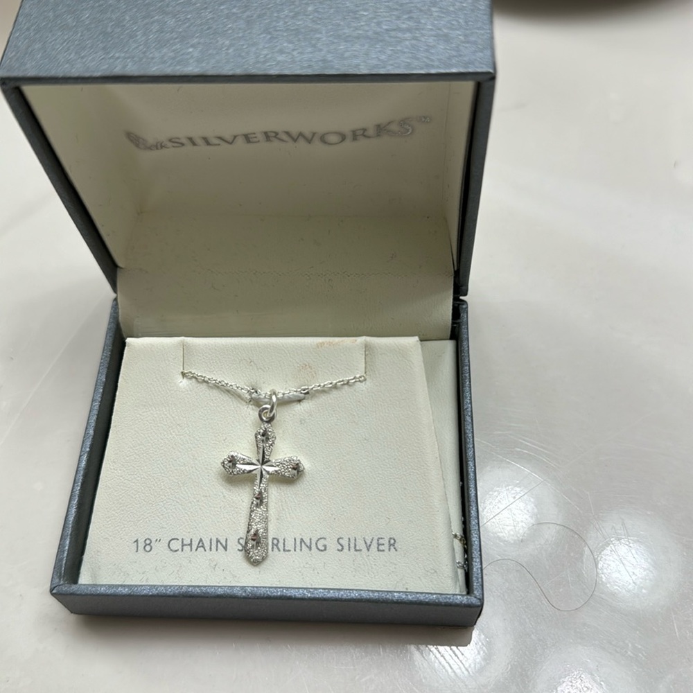 Brand new sterling silver necklace and cross charm